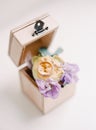 Classic wedding rings lie with flowers in a wooden box. Rustic wedding concept Royalty Free Stock Photo