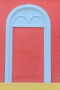 Classic white arch door pattern on the red wall background. Royalty Free Stock Photo