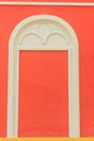 Classic white arch door pattern on the red wall background. Royalty Free Stock Photo
