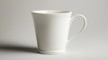 White Ceramic Mug Sits on a Plain Surface Casting a Shadow Royalty Free Stock Photo