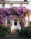 Classic white house with blossom purple flowers