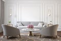 Classic white interior with gray armchairs, sofa, marble coffee table, lamps, carpet, flowers and wall moldings.