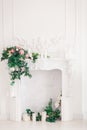 Classic white Interior of living room with fireplace and bouquet of spring flowers on it Royalty Free Stock Photo