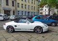 Classic white Porsche convertible sporting private car parked