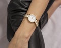 classic white women& x27;s watch in a golden frame on a woman& x27;s hand. Royalty Free Stock Photo