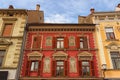 Classic wide-angle view of ancient colorful building. Six windows with wooden shutters. The wall decorated by paintings Royalty Free Stock Photo