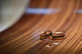 Classic wide wedding rings lie on a wooden surface. Wedding rings and template for text. Close-up