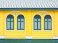 Classic wood window at yellow concrete building. Royalty Free Stock Photo