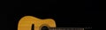 Classic wooden acoustic guitar closeup, on a black background, rock, country music concept. horizontal banner Royalty Free Stock Photo