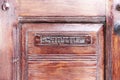 Classic wooden door with mail slot marked with the Spanish word cartas which means letters