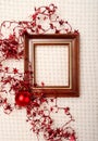 Classic wooden frame decorated with Christmas foil stars and red ball Royalty Free Stock Photo