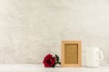 Classic wooden photo frame and red rose with a white coffee cup. - blank space for message and advertising. Royalty Free Stock Photo