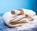 Classic wooden rolling pin with freshly prepared dough and dusting of flour on black background Royalty Free Stock Photo