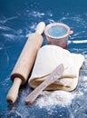 Classic wooden rolling pin with freshly prepared dough and dusting of flour on black background Royalty Free Stock Photo