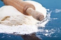 Classic wooden rolling pin with freshly prepared dough and dusting of flour on black background Royalty Free Stock Photo