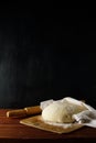 Classic wooden rolling pin with freshly prepared dough and dusting of flour on wooden background Royalty Free Stock Photo