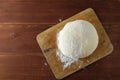 Classic wooden rolling pin with freshly prepared dough and dusting of flour on wooden background Royalty Free Stock Photo