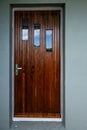 Classic wooden teak door with tree windows..