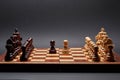 Classic Wooden Tournament chess set on black background. Two pawns in centre of board other pieces lined up Royalty Free Stock Photo