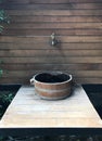 Classic wooden wash basin with brass faucet on wooden wall Royalty Free Stock Photo