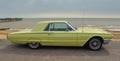 Classic Yellow Thunderbird motor car parked on seafront promenade. Royalty Free Stock Photo