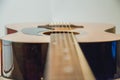 Classical acoustic guitar Detail of an acoustic guitar behind a white background vibrating strings