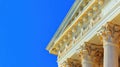 Neoclassical Architecture Detail Column Capital and Entablature Against Blue Sky Royalty Free Stock Photo