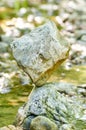 Classical balanced, cube shaped rock at the creek