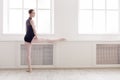 Classical Ballet dancer makes stretching in class Royalty Free Stock Photo