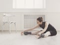 Classical Ballet dancer makes stretching in class Royalty Free Stock Photo