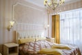 Classical bedroom with a large double bed, bedside tables, chairs
