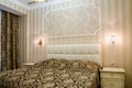 Classical bedroom with a large double bed, bedside tables, chairs