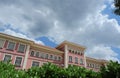 Classical building of an old public school downtown Madrid, Spain. Voluminous cloudscape Royalty Free Stock Photo