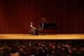 Classical, concert and woman with piano on a stage for performance, entertainment and talent show. Musician, creative Royalty Free Stock Photo