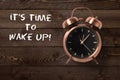 Classical copper colored alarm clock with bells in a Wake Up concept