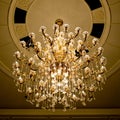 Classical crystal chandelier hanging on beautiful ceiling Royalty Free Stock Photo