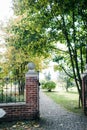 Classical design black wrought iron gate in a beautiful green garden Royalty Free Stock Photo