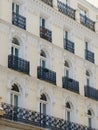 Classical facade with elegant balconies and windows decorated with stucco arches in central district of Madrid, Spain Royalty Free Stock Photo