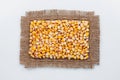 Classical frame made of burlap with grains of corn Royalty Free Stock Photo