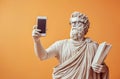 Classical Greek Statue Holding Smartphone and Book Royalty Free Stock Photo