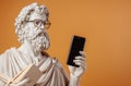 Classical Greek Statue Holding Smartphone and Book Royalty Free Stock Photo