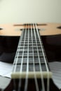 Classical guitar and music sheet, close up and selective focus Royalty Free Stock Photo