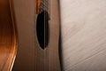 Classical guitar sound hole, fretboard and strings up close on a light wood background Royalty Free Stock Photo