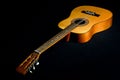 Classical guitar with vibrating strings on a black background