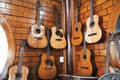 Classical guitars hanging on a wall in a music store. Royalty Free Stock Photo