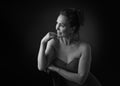 Portrait of a sensual fifty year old woman on grey studio background. Monochrome shot.