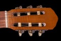 Classical headstock of acoustic guitar close-up on black background