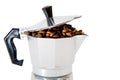 Classical Italian coffee maker pot filled with coffee beans Royalty Free Stock Photo