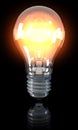 Classical light bulb shining, on, on black Royalty Free Stock Photo