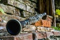 Classical music concept. Old dirty clarinet on a background of a beautiful old broken brick wall Royalty Free Stock Photo